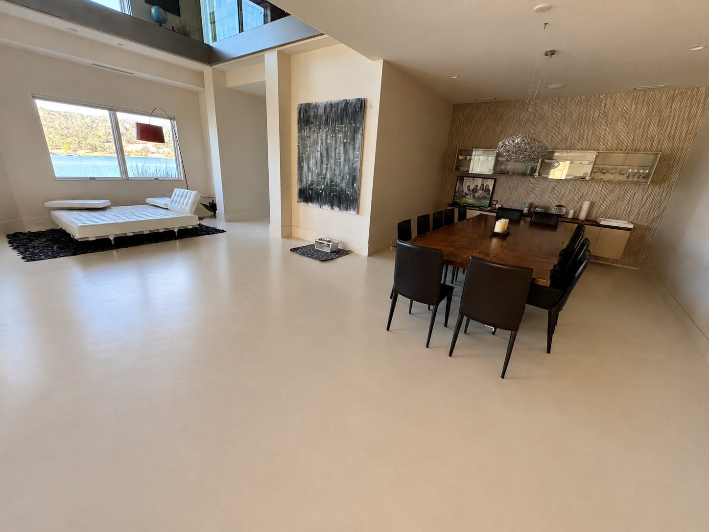 Continuous microcement floor across an open-plan living and dining area in Gold Country, Northern California