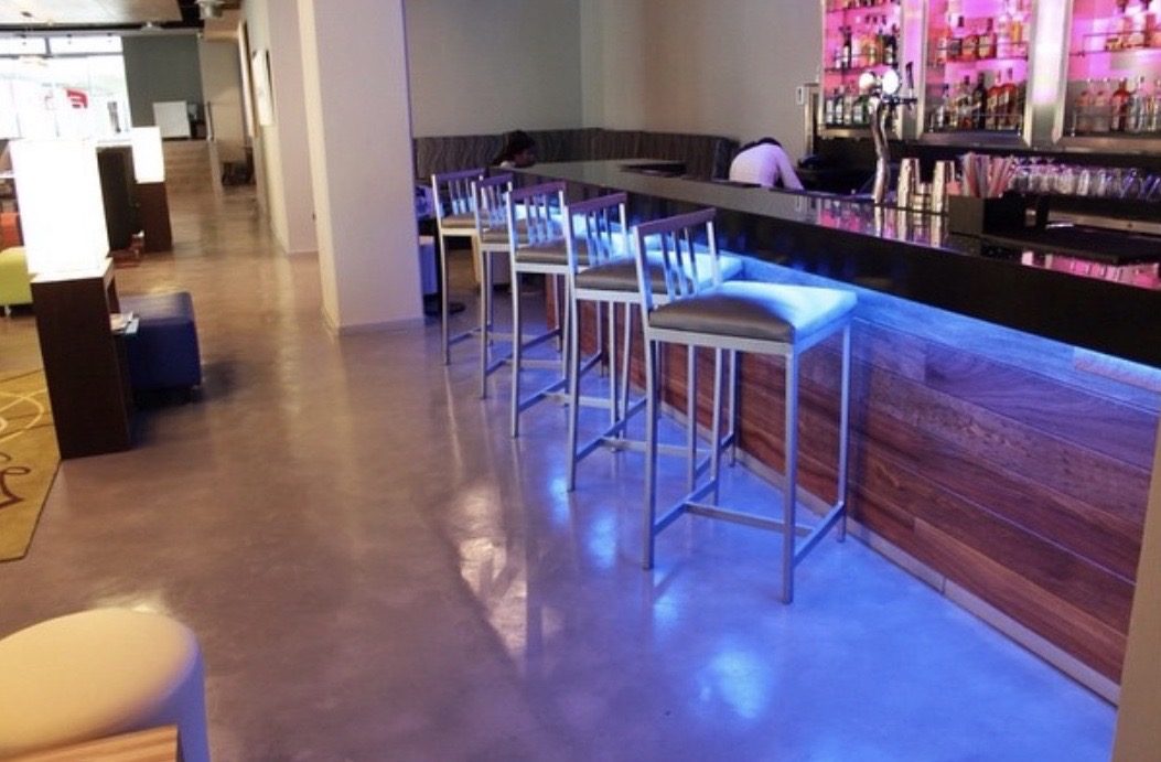 Polished microcement floor in a hospitality bar interior