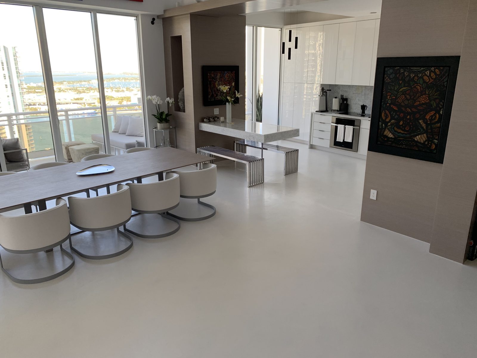 Seamless microcement floor in a Brickell high-rise condo with Biscayne Bay views, Miami