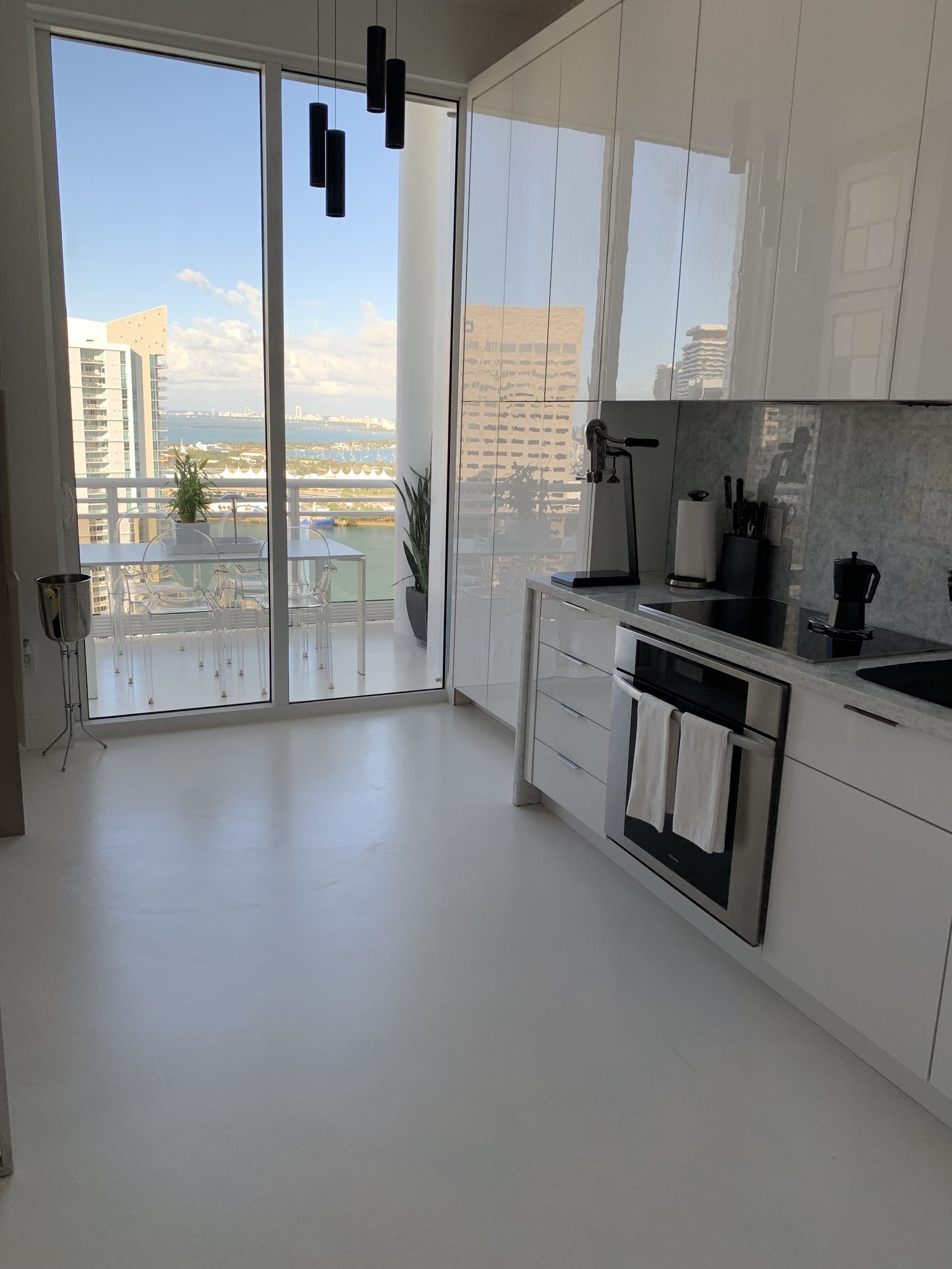 Microcement kitchen floor running to the terrace in a Brickell condominium, Miami