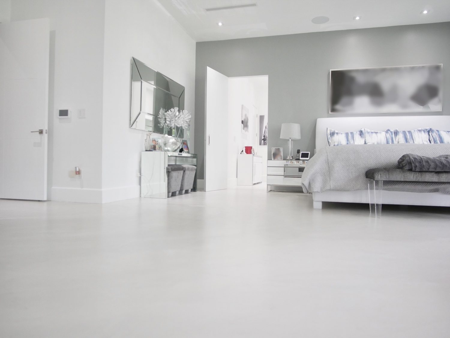 Seamless light microcement floor in a primary bedroom of an Avalon home on the Jersey Shore, New Jersey