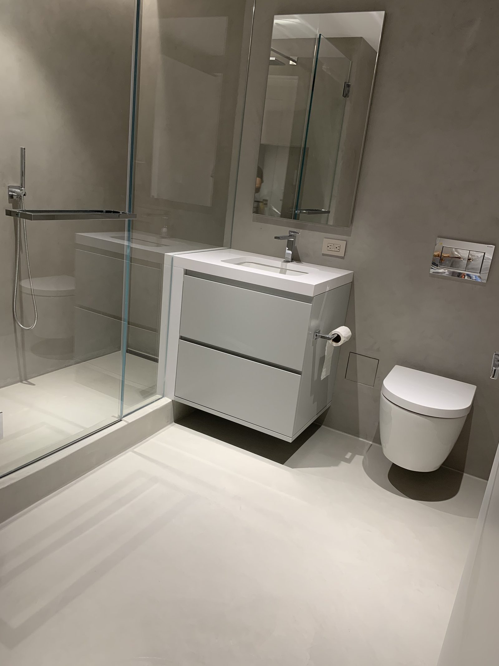 Microcement bathroom with seamless walls and floor in a Manhattan apartment, New York