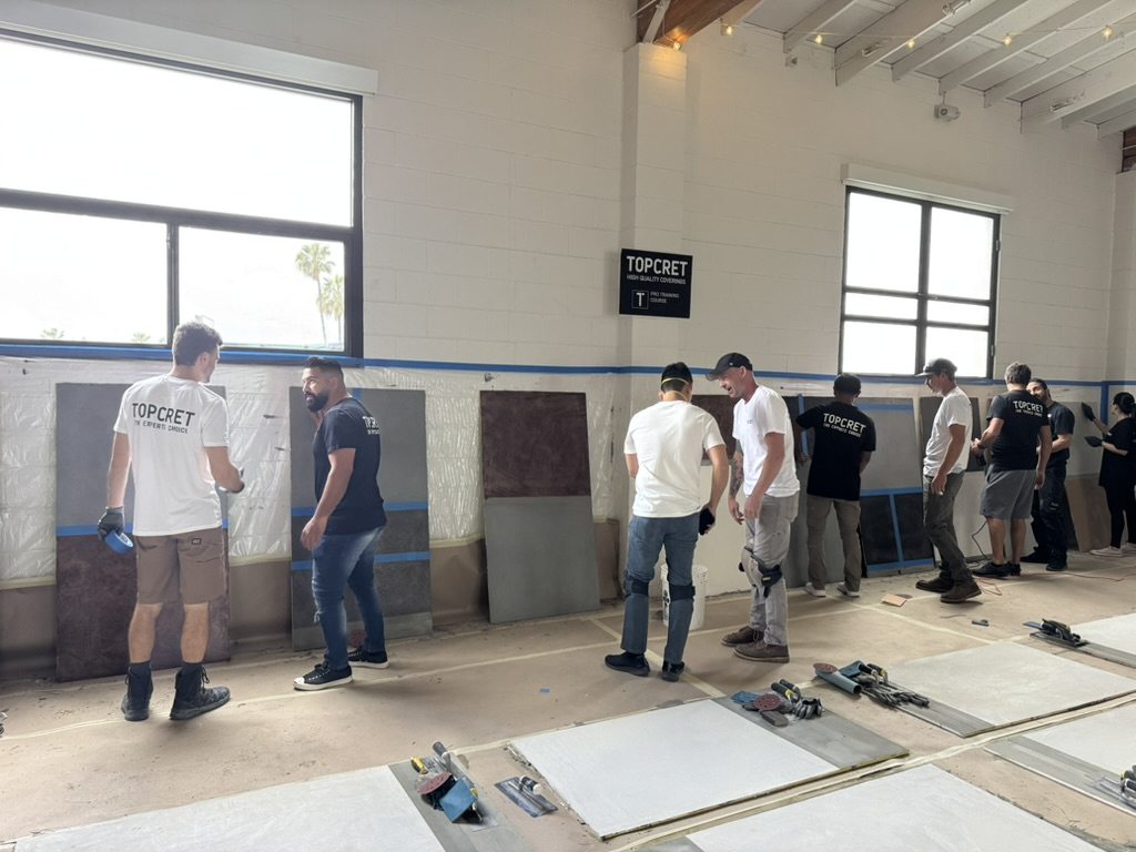 Topcret USA microcement training session with applicators working on sample boards