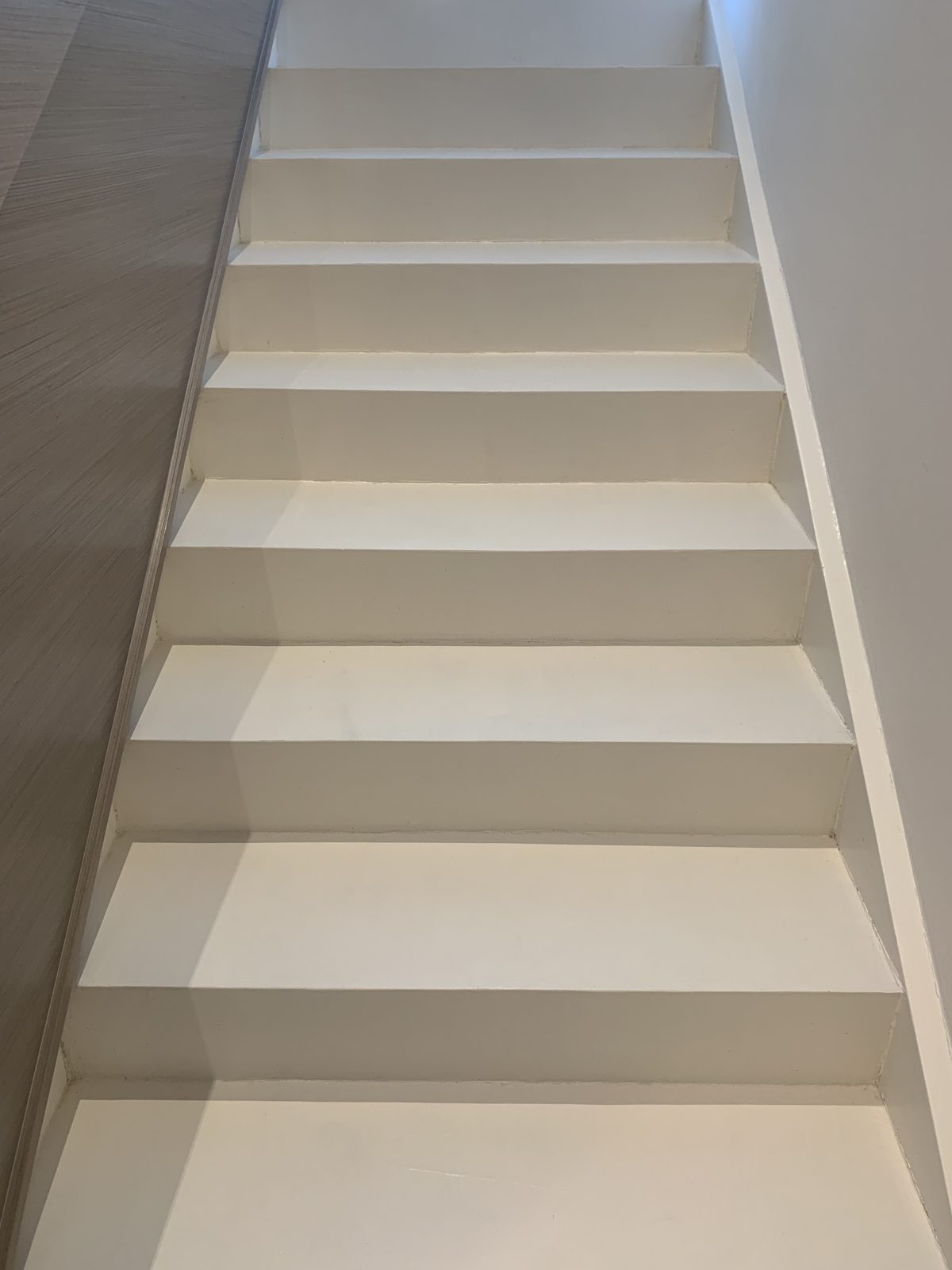Seamless white EcoCemento microcement staircase