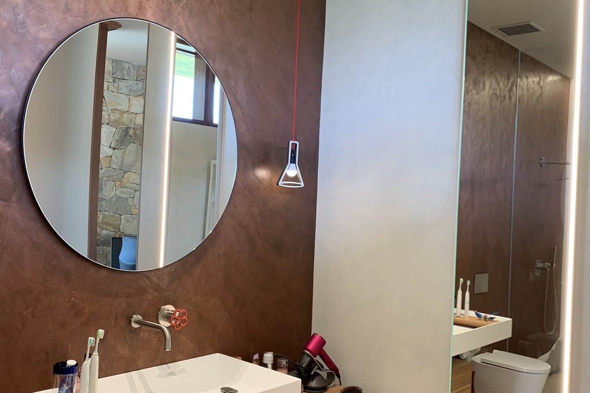 Real Metals bronze accent wall with vanity